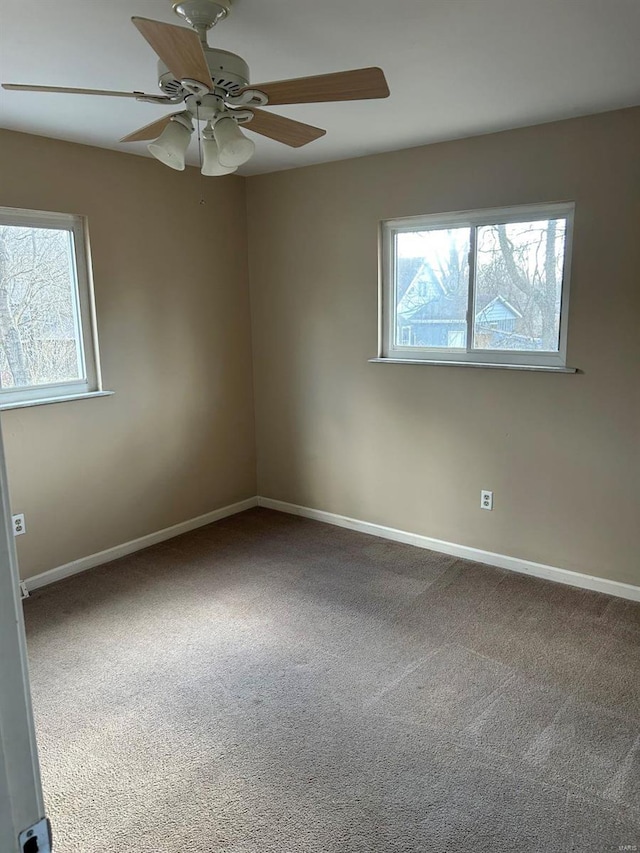 spare room with baseboards, a healthy amount of sunlight, and carpet flooring