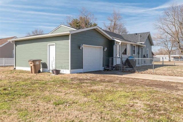 exterior space featuring a front yard, a garage, and fence