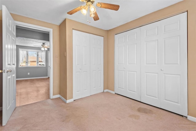 unfurnished bedroom featuring baseboards, light carpet, and a ceiling fan