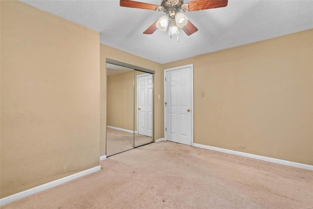 unfurnished bedroom with carpet, baseboards, and a closet