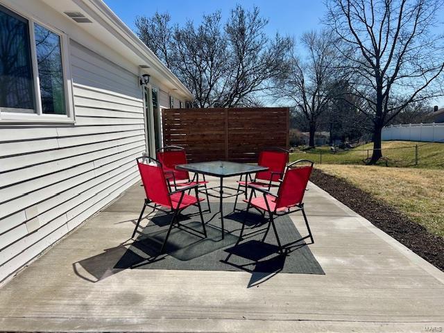 view of patio featuring outdoor dining space and fence