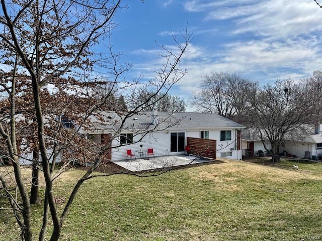 back of property featuring a patio and a yard