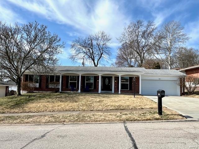 ranch-style home with a porch, an attached garage, concrete driveway, and brick siding