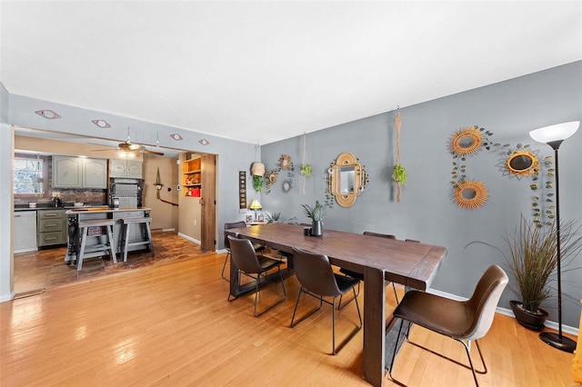 dining room with baseboards and light wood finished floors