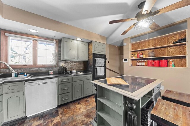 kitchen featuring dishwashing machine, a sink, gray cabinetry, and open shelves