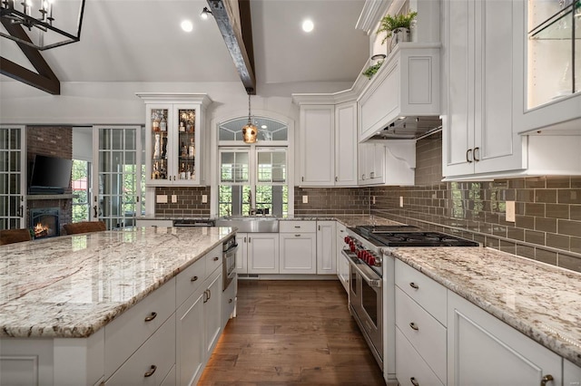 kitchen featuring white cabinetry, double oven range, and a sink