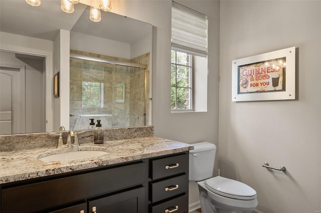 full bath with vanity, toilet, and a stall shower