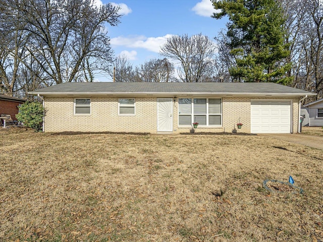 ranch-style house with brick siding, driveway, a front lawn, and a garage