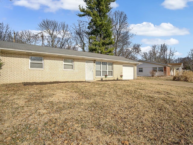 exterior space with brick siding, a lawn, and an attached garage