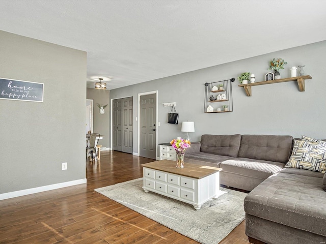 living room with wood finished floors and baseboards