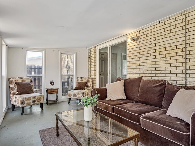 living area with brick wall and concrete floors