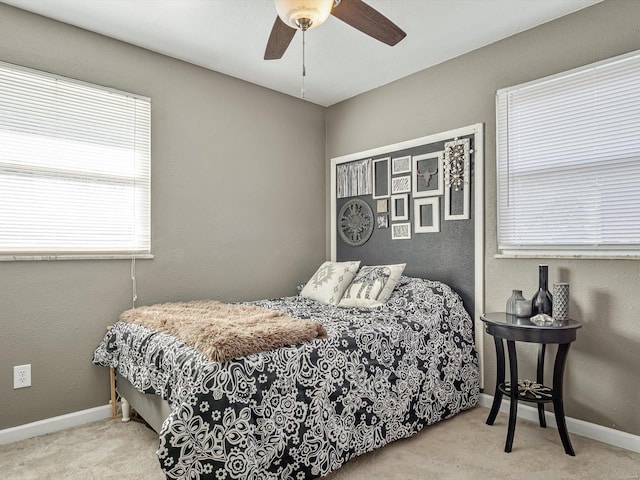 carpeted bedroom featuring baseboards and ceiling fan