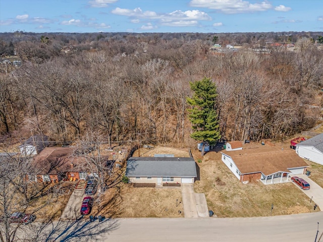 birds eye view of property with a wooded view