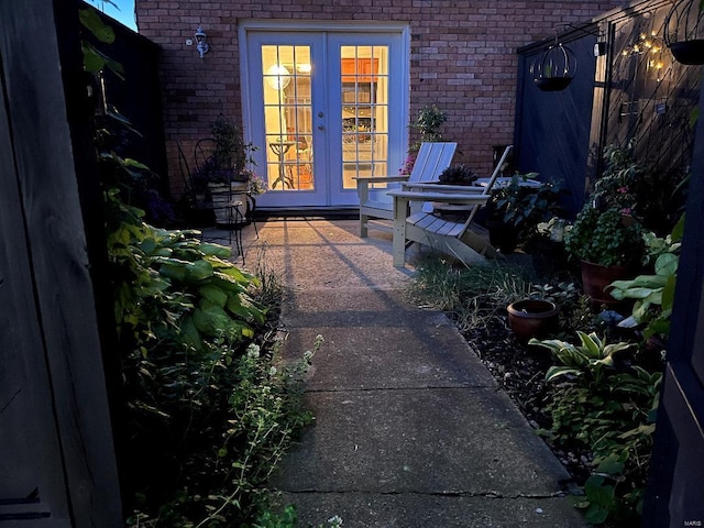 doorway to property featuring french doors and brick siding