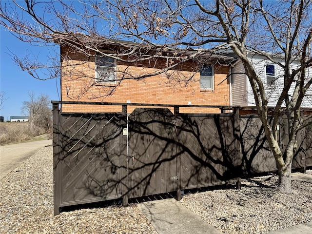 view of side of home with brick siding