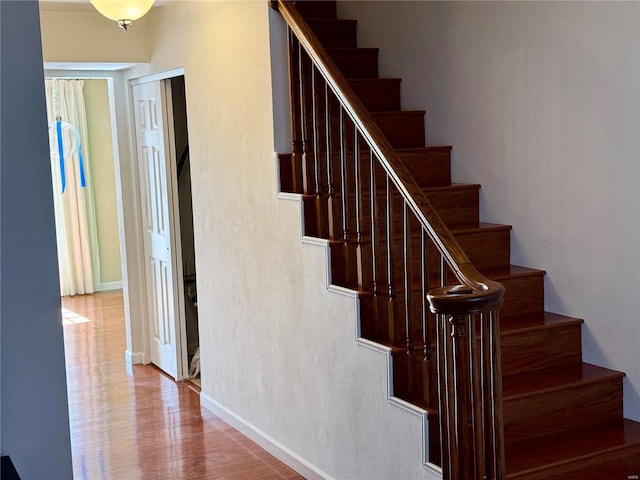 stairs featuring baseboards and wood finished floors