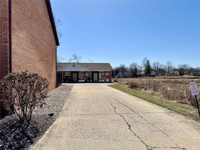 view of front facade with brick siding and driveway