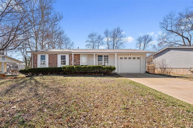 ranch-style home featuring a front lawn, brick siding, a garage, and driveway