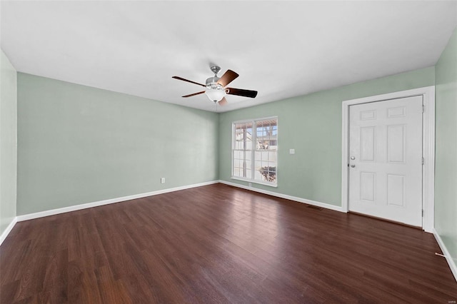 unfurnished living room with visible vents, baseboards, dark wood-type flooring, and a ceiling fan