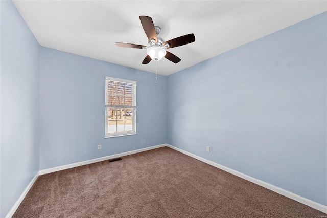 unfurnished room with visible vents, baseboards, a ceiling fan, and carpet flooring