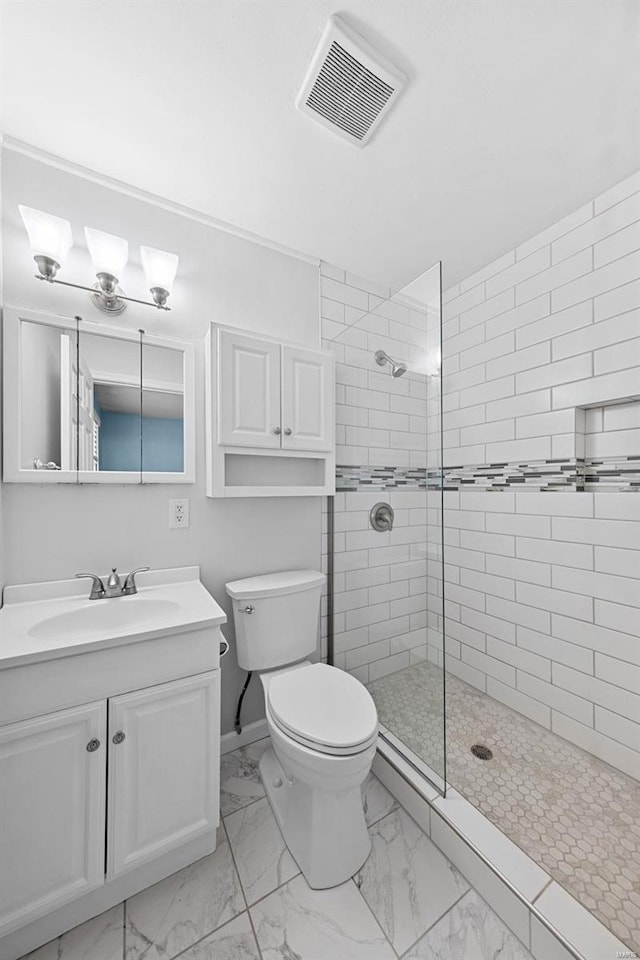 full bath with visible vents, toilet, marble finish floor, a tile shower, and vanity