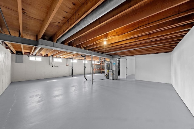 basement with electric panel and gas water heater