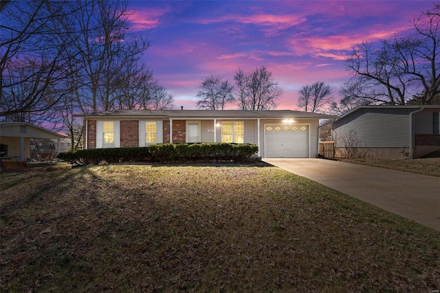 ranch-style house with brick siding, a garage, driveway, and a lawn