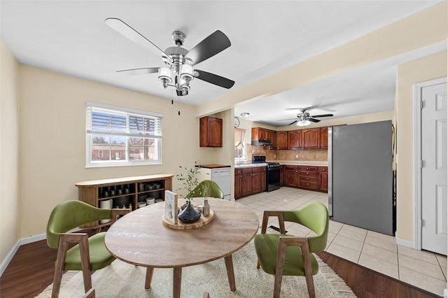 dining area with light tile patterned floors, baseboards, and ceiling fan