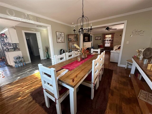 dining room with ornamental molding, a brick fireplace, and dark wood finished floors