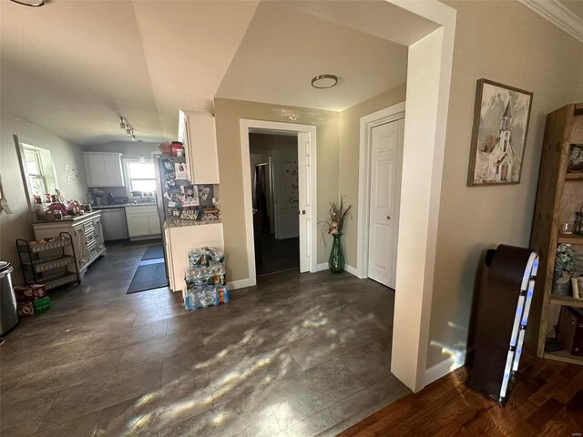 interior space with lofted ceiling and baseboards