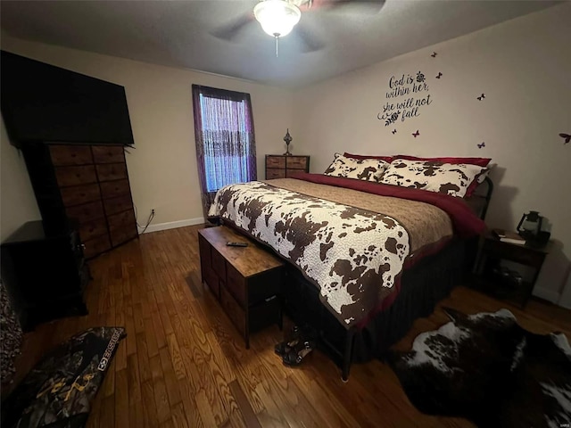 bedroom with ceiling fan, baseboards, and wood finished floors