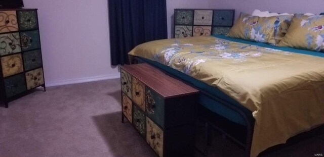 bedroom featuring carpet and baseboards