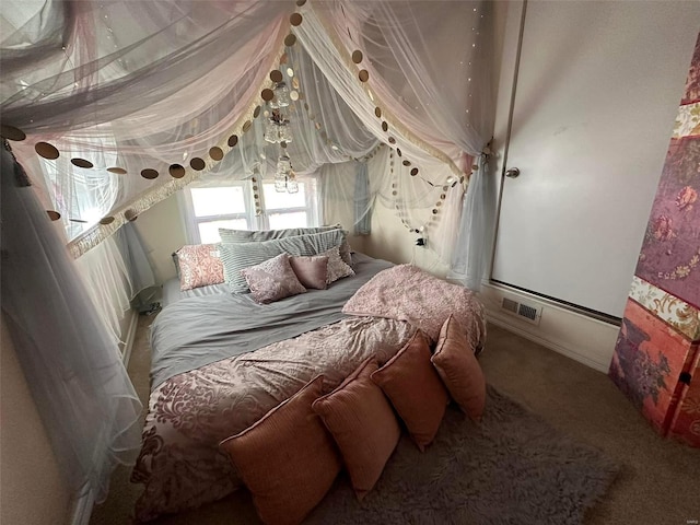 bedroom with visible vents and carpet flooring