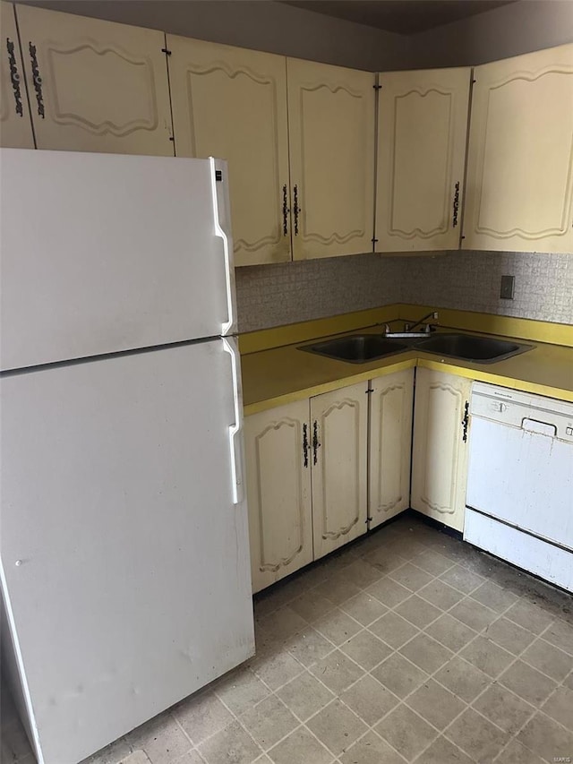 kitchen with white appliances and a sink