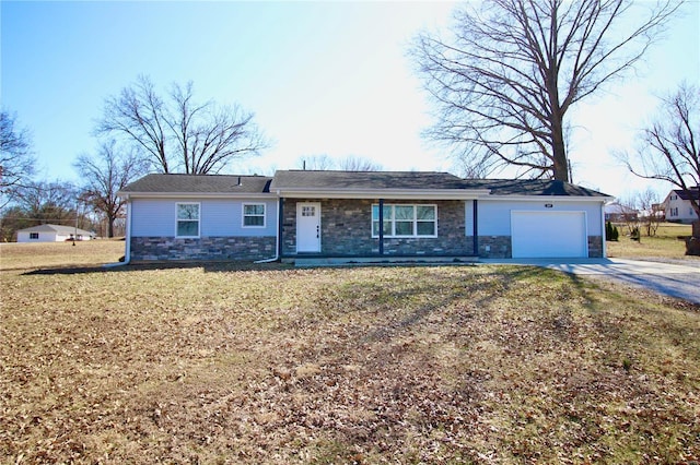 ranch-style house with a garage, stone siding, concrete driveway, and a front yard