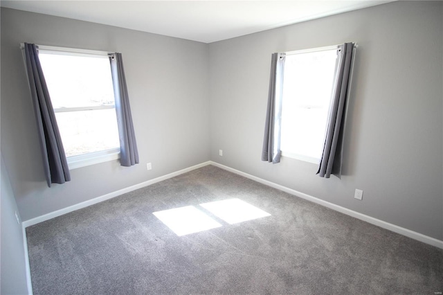 carpeted spare room with baseboards