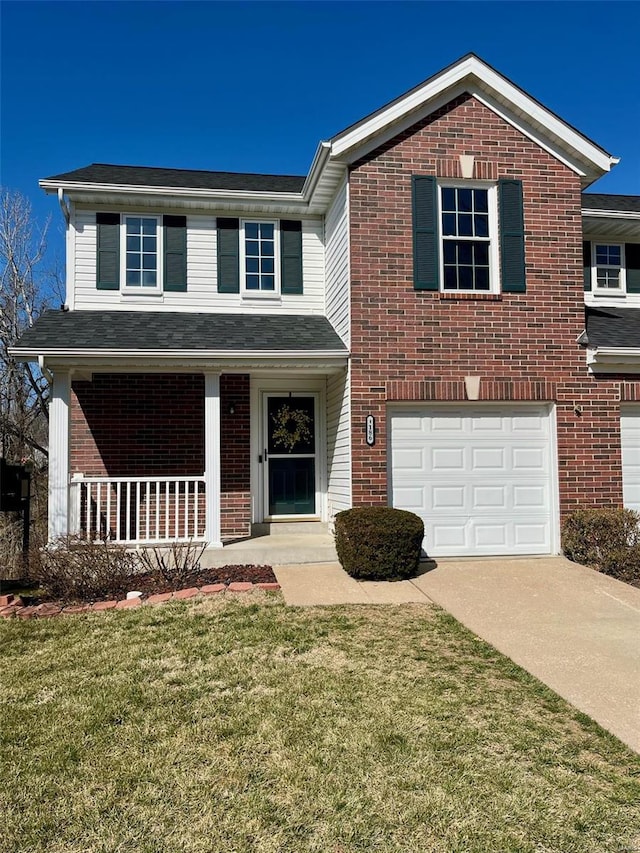 traditional home featuring a garage, covered porch, brick siding, driveway, and a front yard