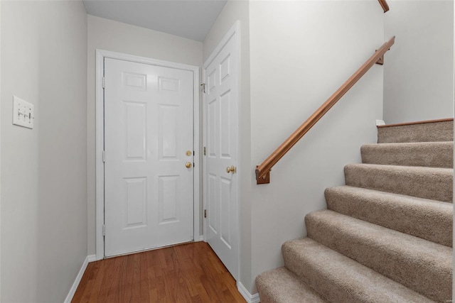 doorway to outside with stairs, wood finished floors, and baseboards