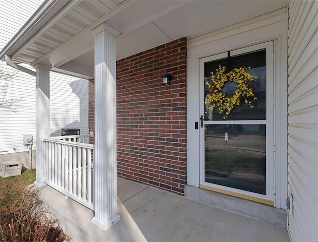 view of exterior entry with brick siding