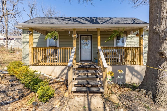 view of front of property with a porch and a shingled roof