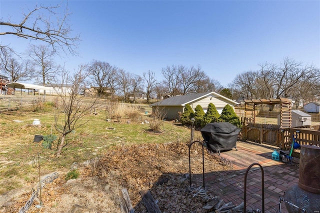 view of yard with a wooden deck and a patio