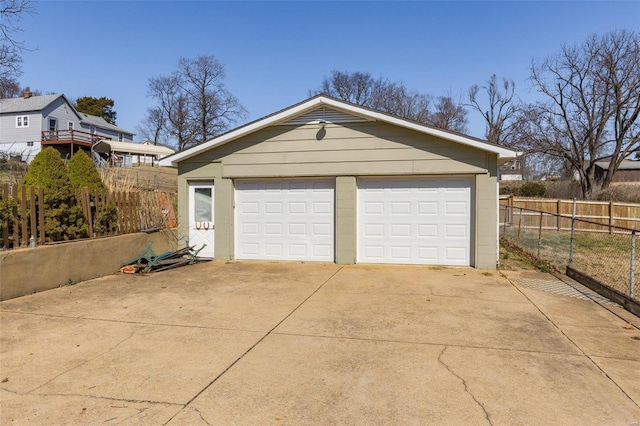 detached garage featuring fence