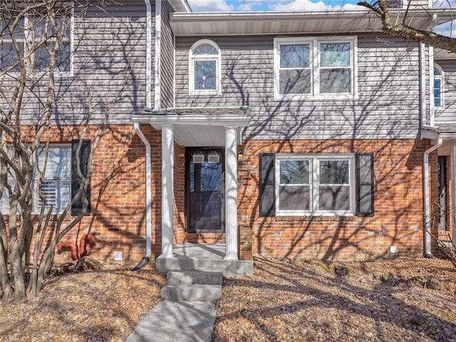 view of front of property with brick siding and crawl space