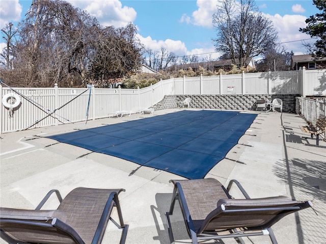 view of swimming pool with a fenced in pool, a fenced backyard, and a patio area