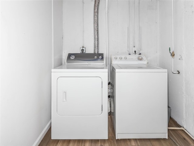 washroom with laundry area, wood finished floors, and separate washer and dryer