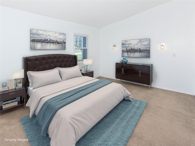 bedroom with baseboards, carpet, and vaulted ceiling