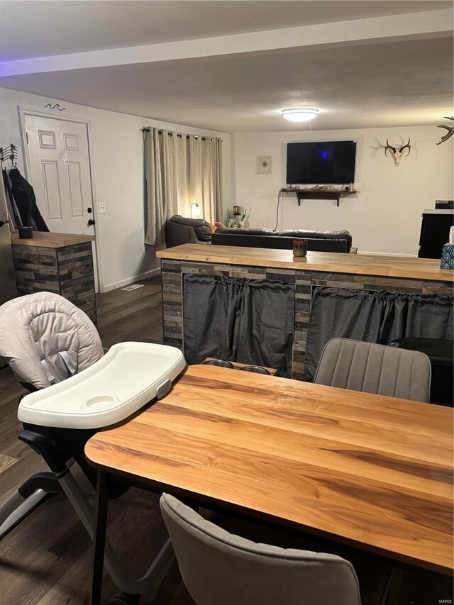 dining space featuring baseboards and wood finished floors