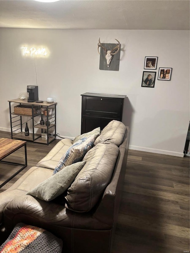 living area featuring wood finished floors and baseboards