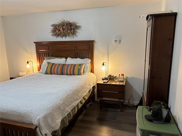 bedroom with dark wood-style flooring