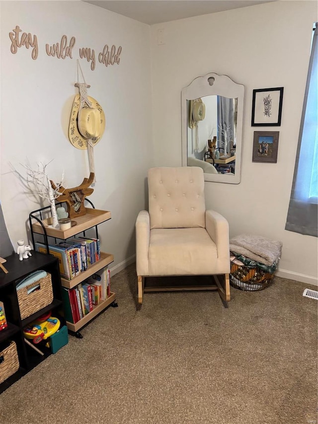 sitting room with visible vents, carpet, and baseboards